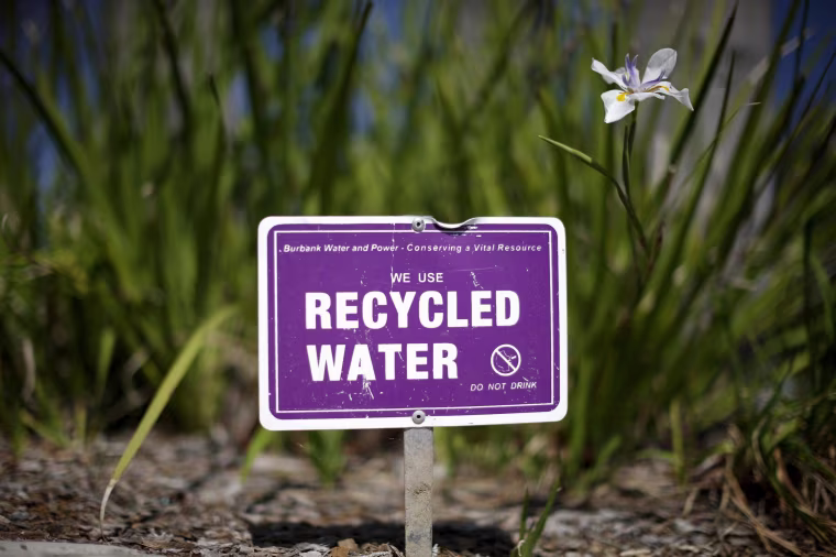 Image: A sign indicating that recycled water is used to water plants is seen in Burbank, Los Angeles