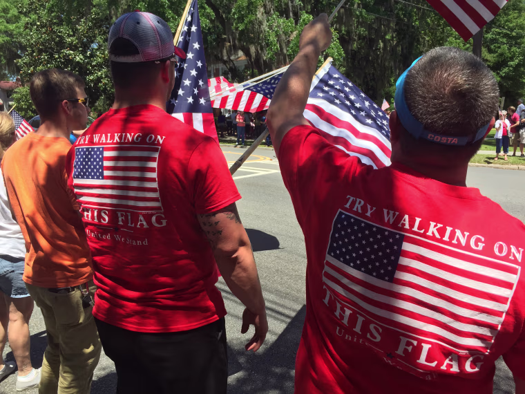 Demonstrators wave American flags at Valdosta State University.