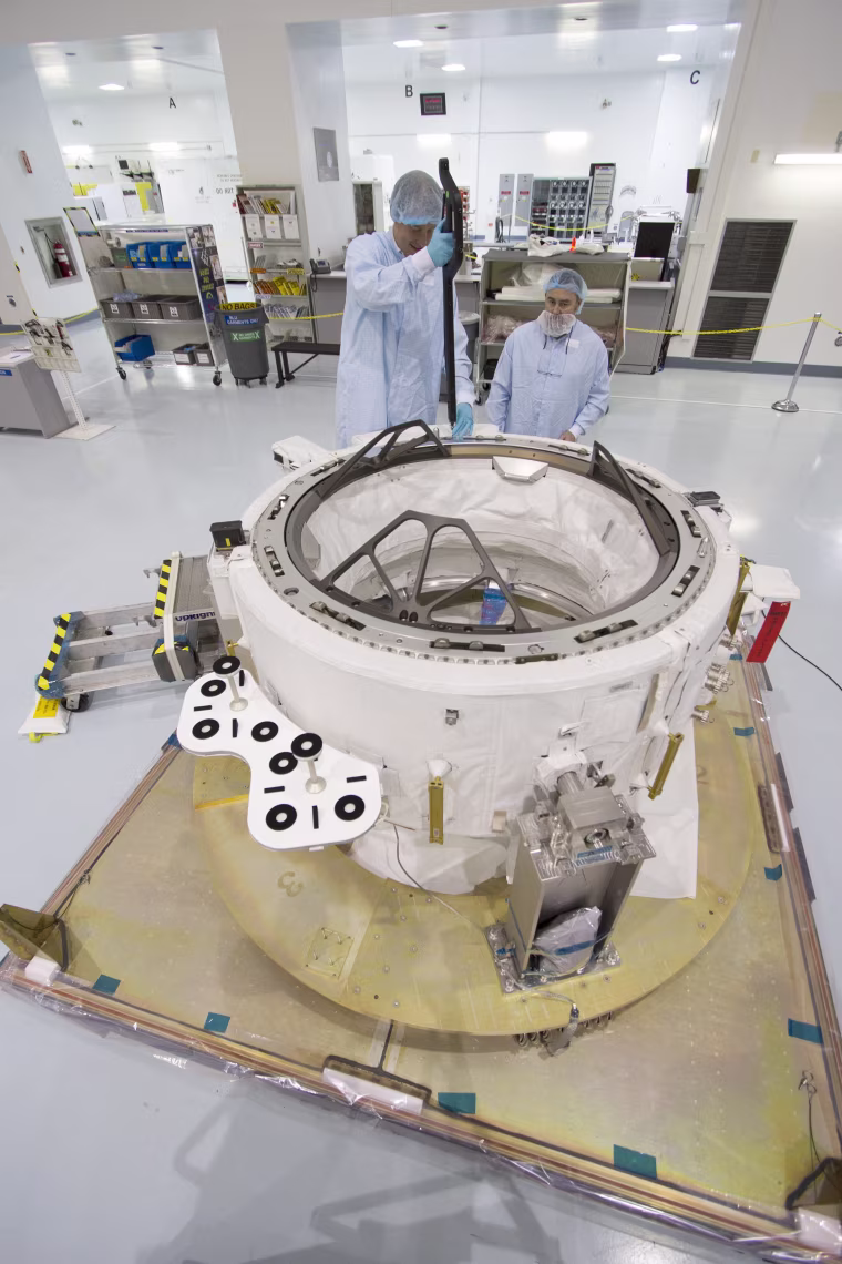 Image: Engineers check measurements on the International Docking Adapter