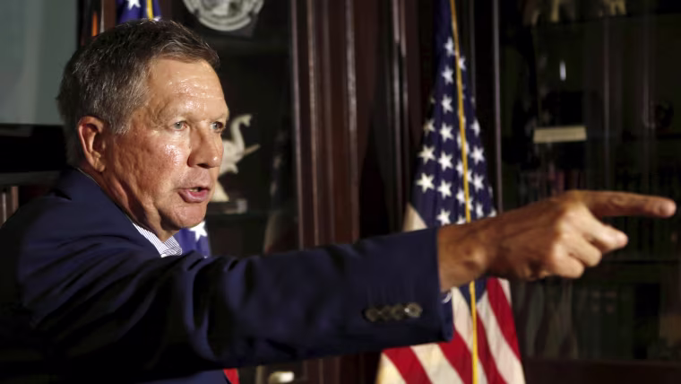 Image: Republican Ohio Governor John Kasich gestures at a news conference