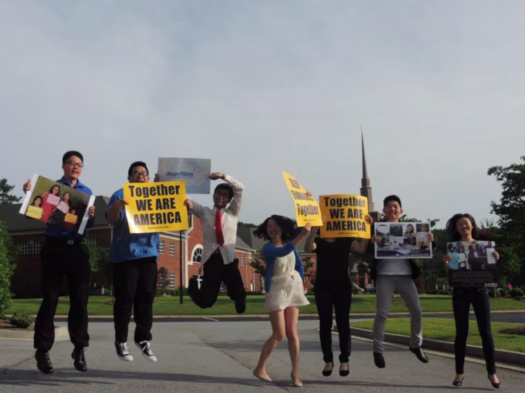 Image: Dream Riders holding signs.