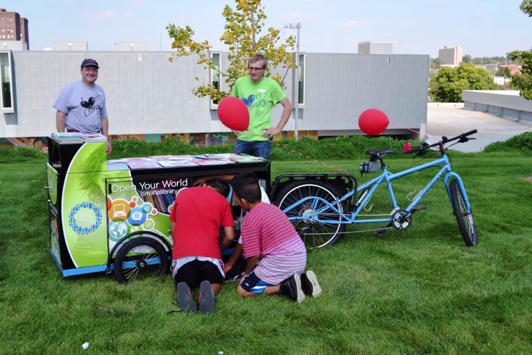 Children browse the books in a "Book On Bikes library"