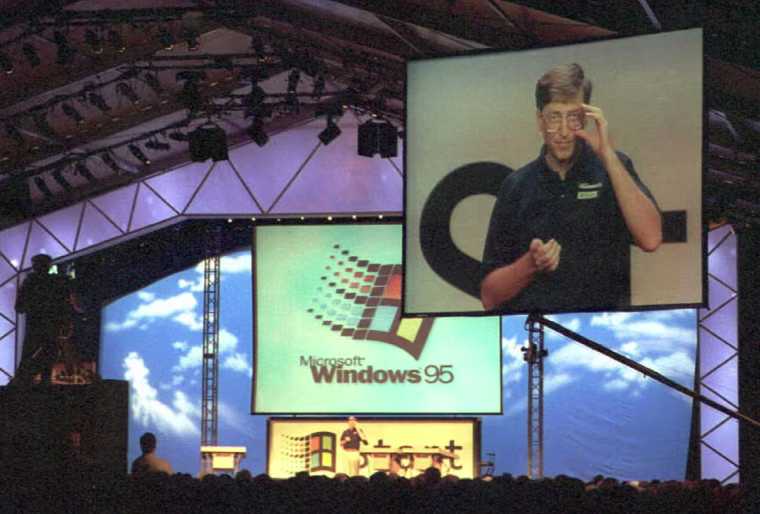 Image: Microsoft Chairman Bill Gates is televised on a big screen as he introduces Windows 95