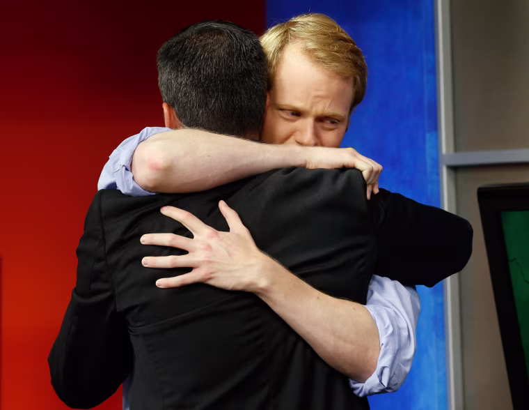 Image: WDBJ-TV7 anchor Chris Hurst, right, hugs meteorologist Leo Hirsbrunner