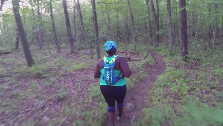 Mirna Valerio runs through a forest.