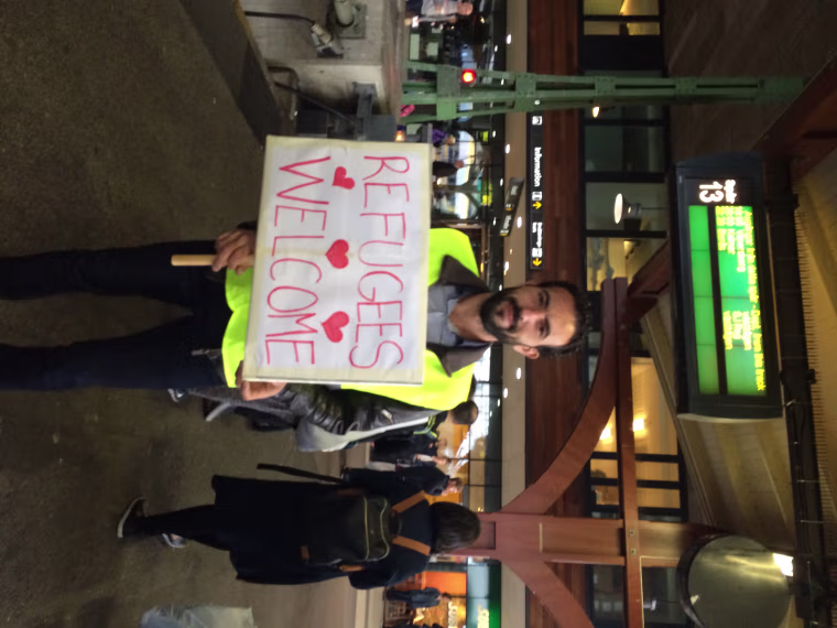 Image: Residents welcome refugees on train platform in Gutenberg, Sweden