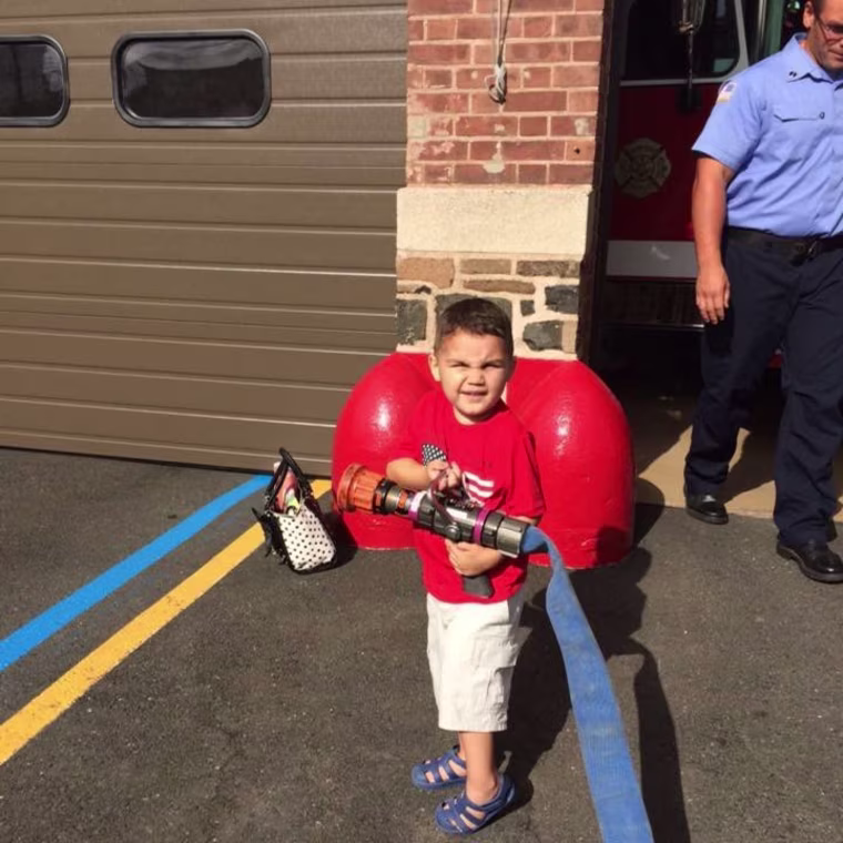 Give the kid a fire hose and he's all smiles.