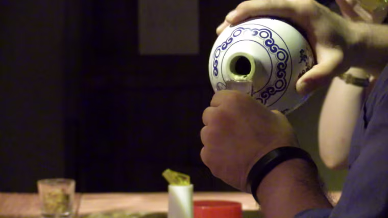 Image: Florida bartender David Putney pours baijiu intro a traditional glass