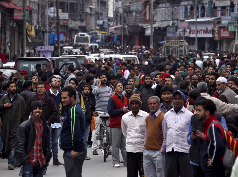 Image: People stand on a road after vacating buildings