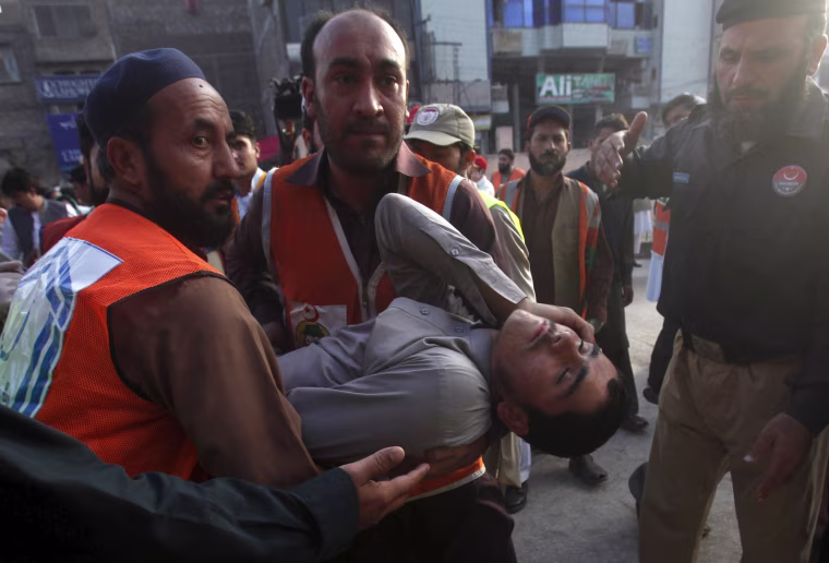 Image: Rescue workers carry an injured man