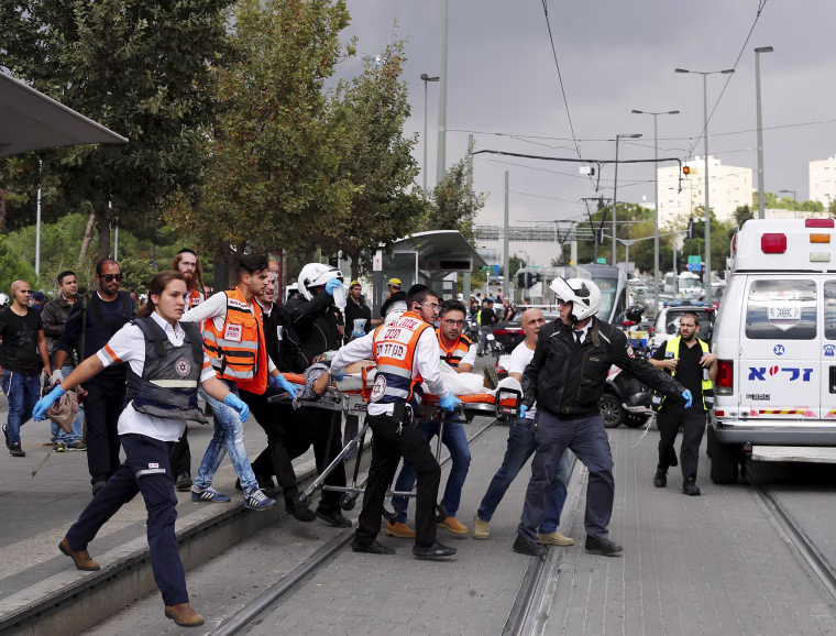 Image: Medics evacuate an injured man in Jerusalem