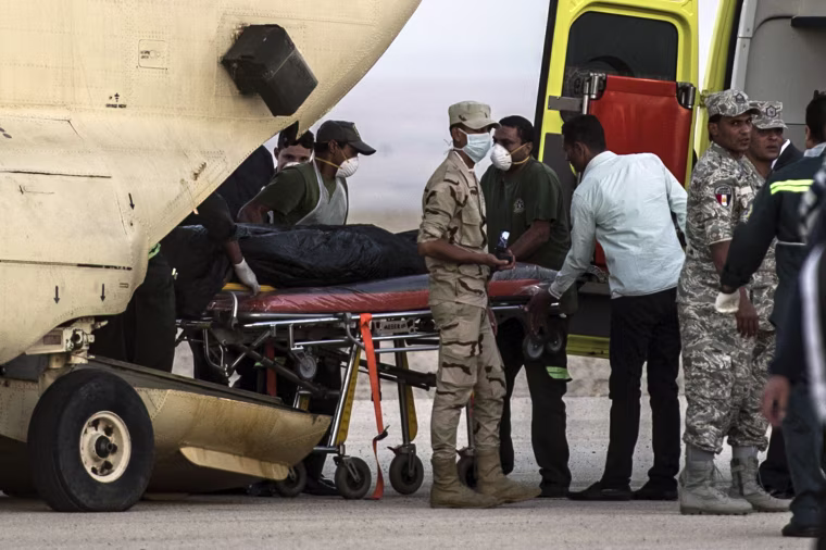 Image: Egyptian paramedics load bodies of plane crash victims