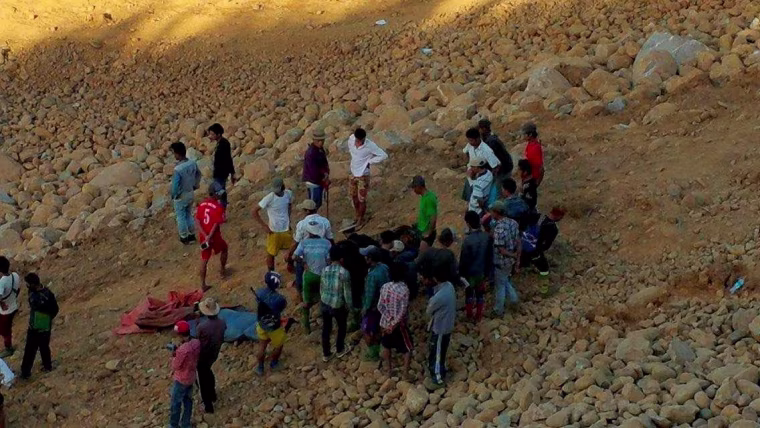 Image: People look for dead bodies following a landslide in Kachin state