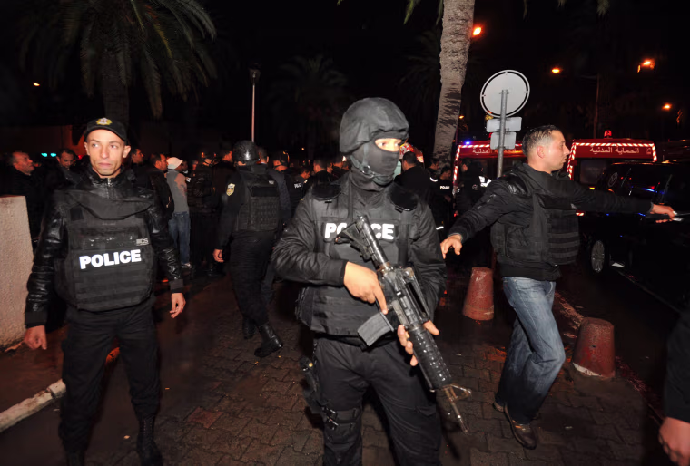 Image: Tunisian police block the road leading to the site of an explosion