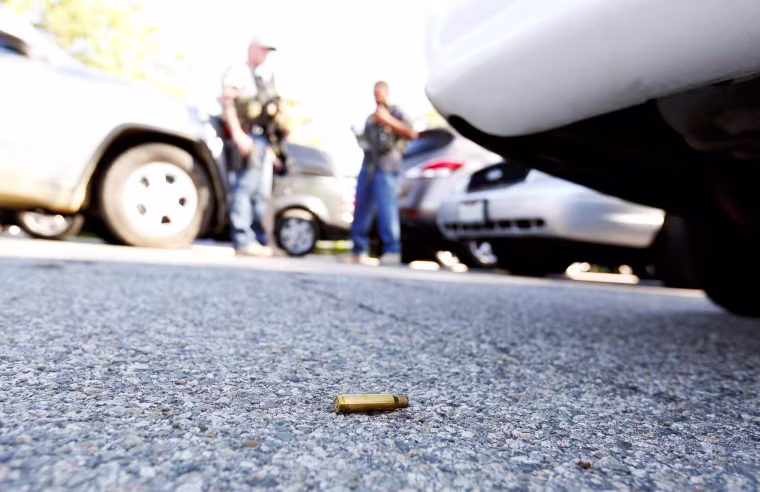 Image: A spent cartridge lies on the ground