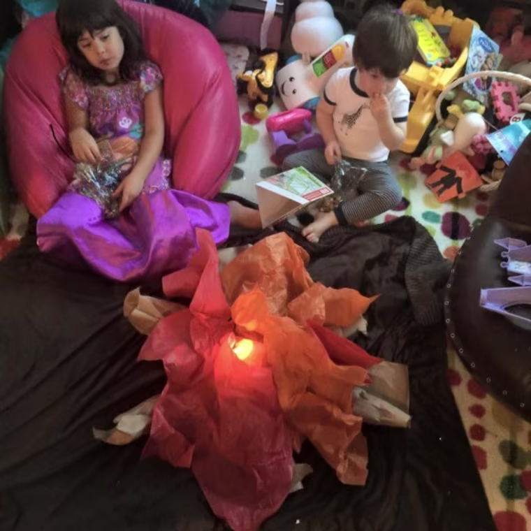 Angie Goff's kids enjoy a make-believe campfire at home.