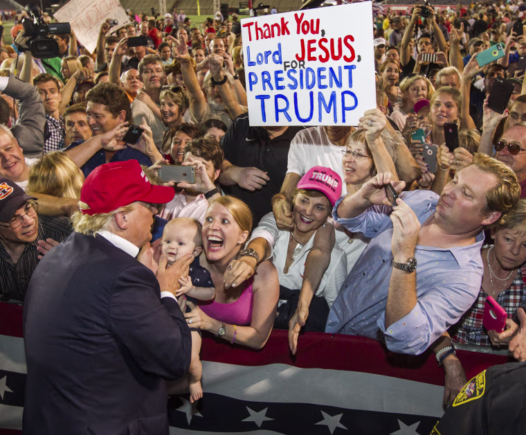 Image: Republican presidential candidate Donald Trump greets supporters
