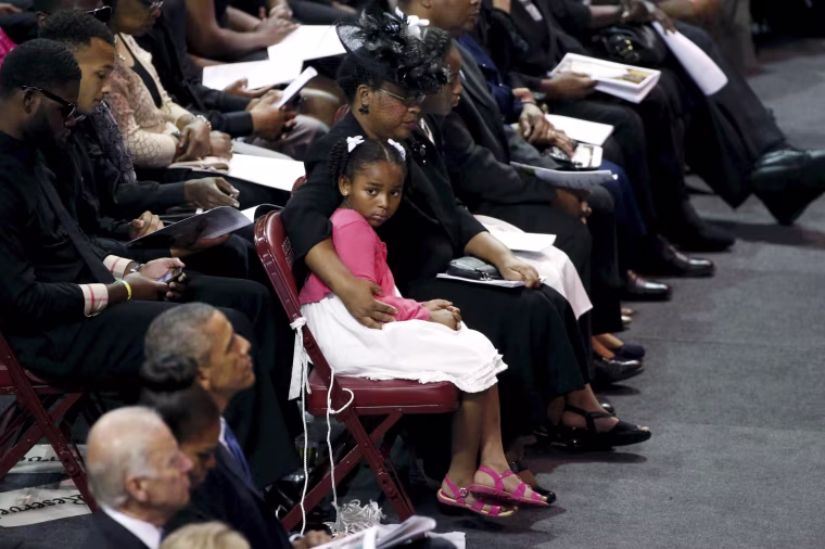 Image: Malana Pinckney, daughter of Reverand Clementa Pinckney, is hugged by her mother Jennifer at the start of her father's funeral in South Carolina