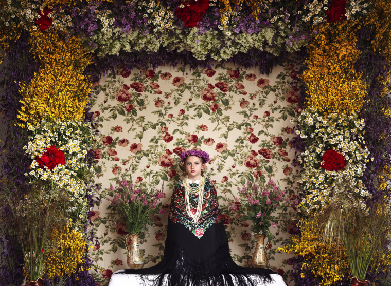 Image: A 'Maya' girl sits in an altar during the traditional celebration of 'Las Mayas'