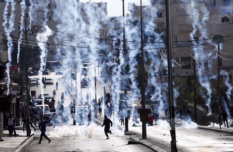 Image: Palestinians dressed up as Santa Claus demonstrate