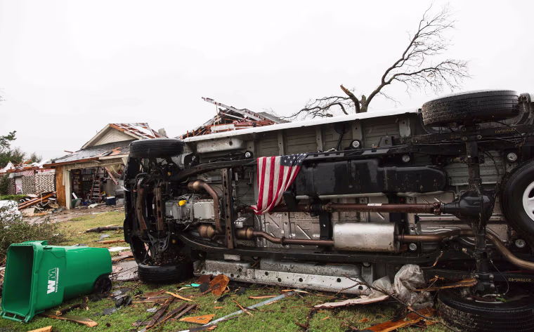 Image: An American flag placed by first responders is seen in the aftermath of a tornado in Rowlett, Texas.