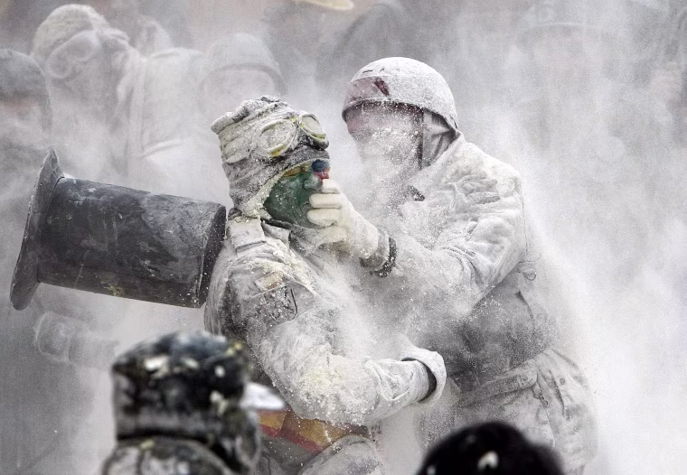 Image: People take part in the flour fight as part of the winter festival in Ibi, Alicante, eastern Spain