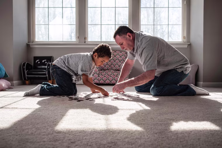 Image: Steve Elmore plays with his oldest son, Zion