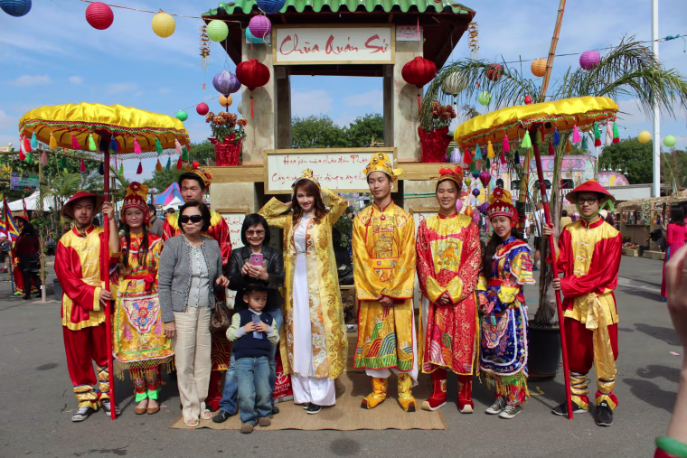 The UVSA Tet Festival royal court pose in front of a recreation of a Vietnamese temple.