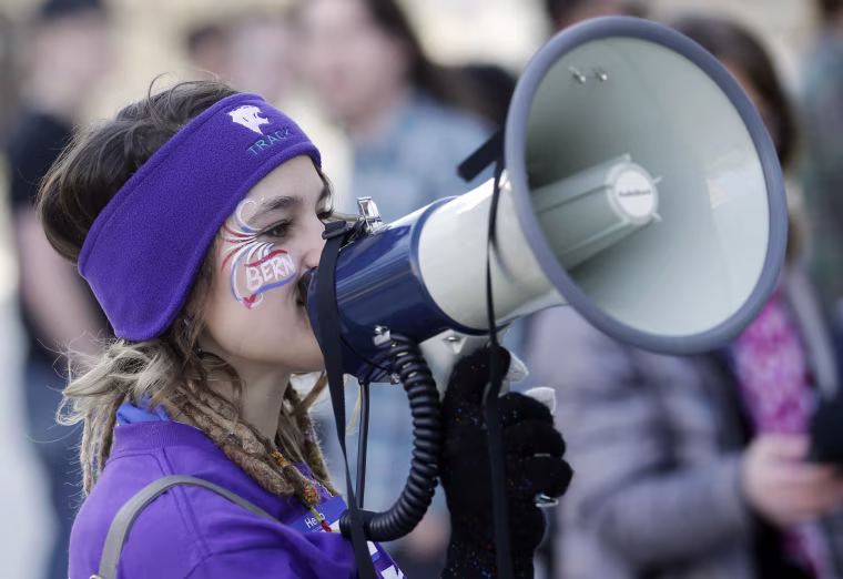Image: Precinct captain Hayley Hageman instructs people through a bullhorn