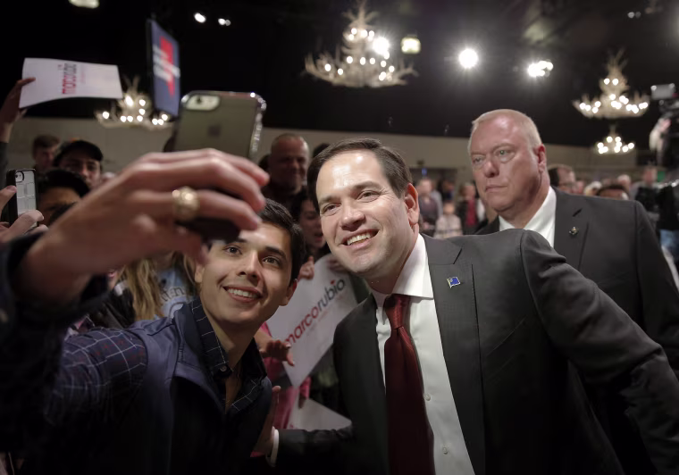 Image: Marco Rubio poses for a photo with a supporter
