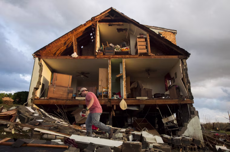 Image: Nick Mobley helps clean up a house owned by a family friend