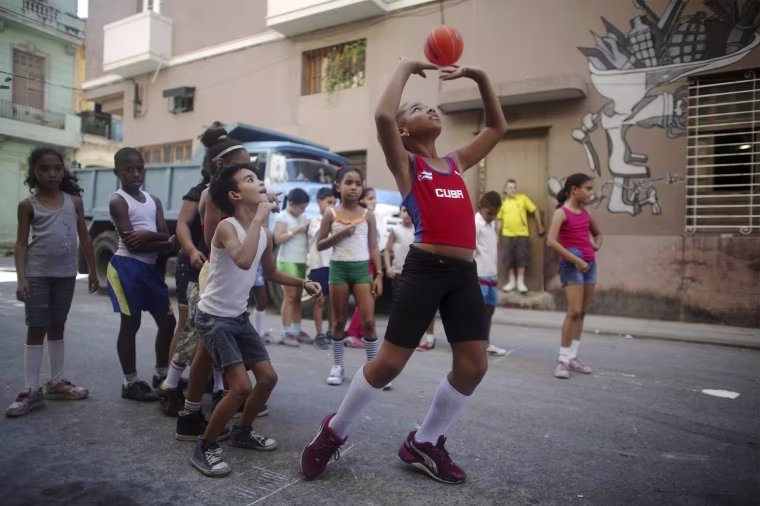 Image: Amanda Bonnell exercises with schoolmates on a street in downtown Havana
