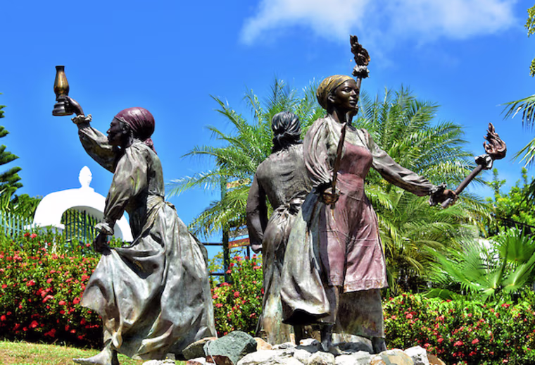 The bronze sculpture of the historic Three Queens placed in Blackbeard's Castle garden.