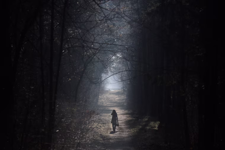 A woman strolls in the Grunewald forest in Berlin.