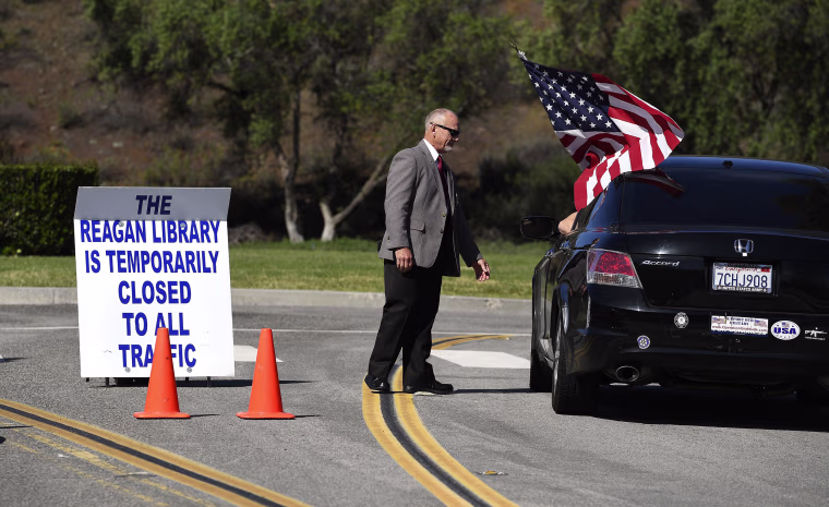 Image: Security guard Doug Wiley tells Andy Hall that the Ronald Reagan Presidential Library is closed