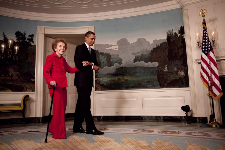 President Barack Obama escorts former First Lady Nancy Reagan in the Diplomatic Room of the White House on June 2, 2009.