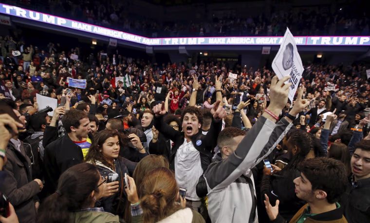Image: Demonstrators celebrate after Republican U.S. presidential candidate Donald Trump cancelled his rally at the University of Illinois in Chicago
