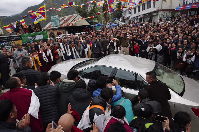 Image: Exile Tibetans welcome their spiritual leader the Dalai Lama as he arrives in Dharamsala