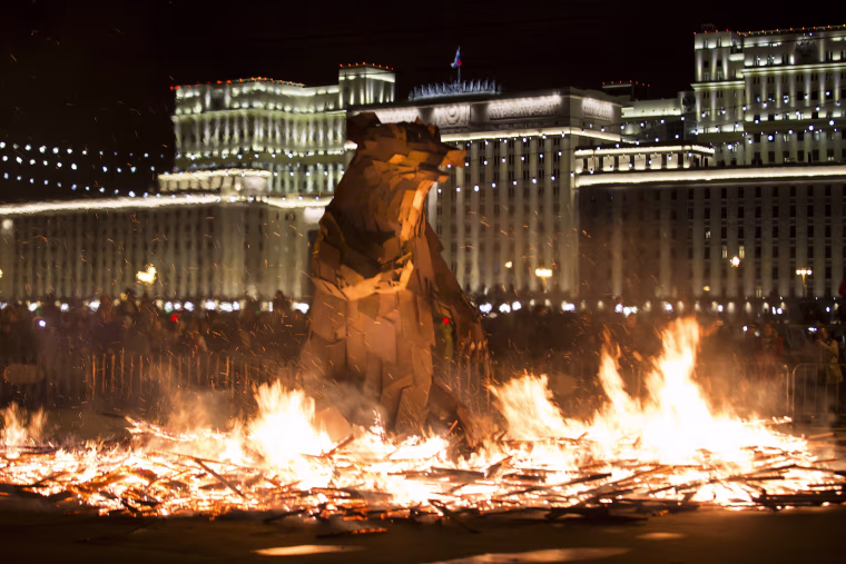 Image: People watch the burning symbol of spring