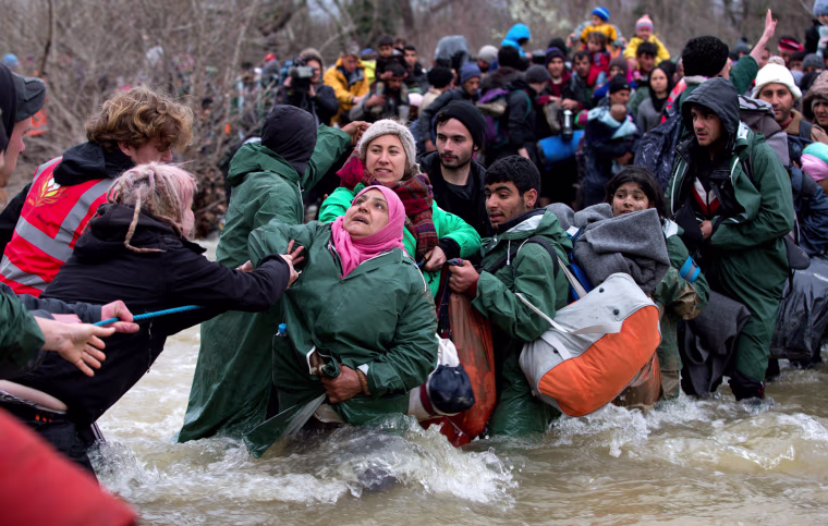 Image: Frustrated Migrants Stranded On The Border Attempt To Walk In To Macedonia