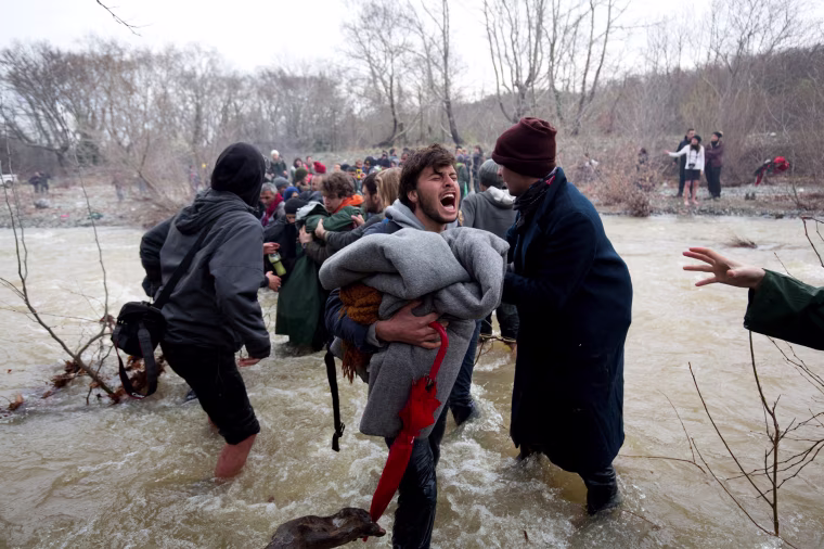 Image: Frustrated Migrants Stranded On The Border Attempt To Walk In To Macedonia