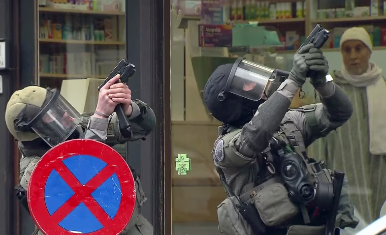 Image: Armed Belgian police secure the area upon their arrival in Molenbeek, near Brussels