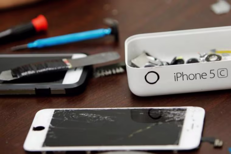 Pieces of an iPhone are seen on a repair store in New York