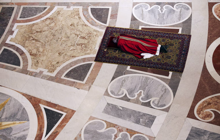 Image: Pope Francis lies as he prays during the Celebration of the Lord's Passion in Saint Peter's Basilica at the Vatican