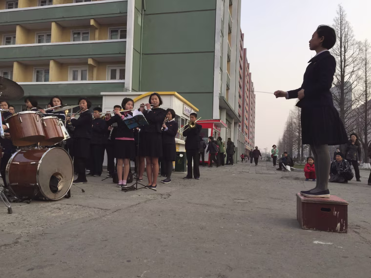 Image: Schoolchildren play music to entertain and inspire people on their way home from work