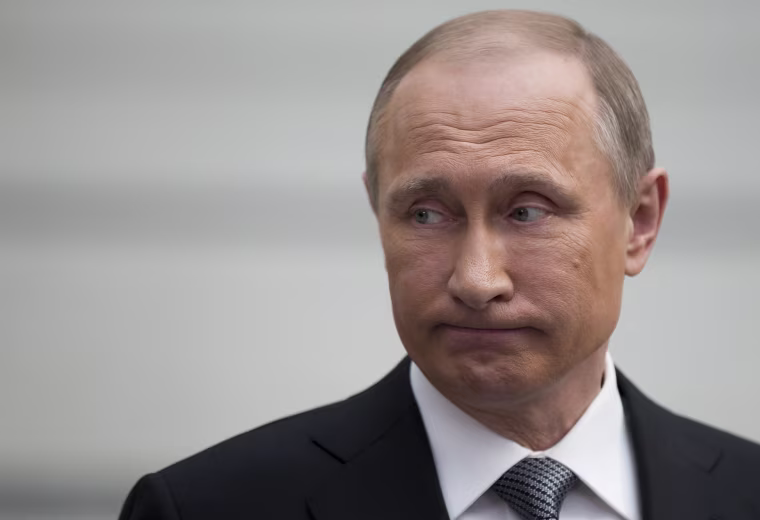 Image: Russian President Vladimir Putin grimaces as he speaks to the media after his annual call-in show in Moscow