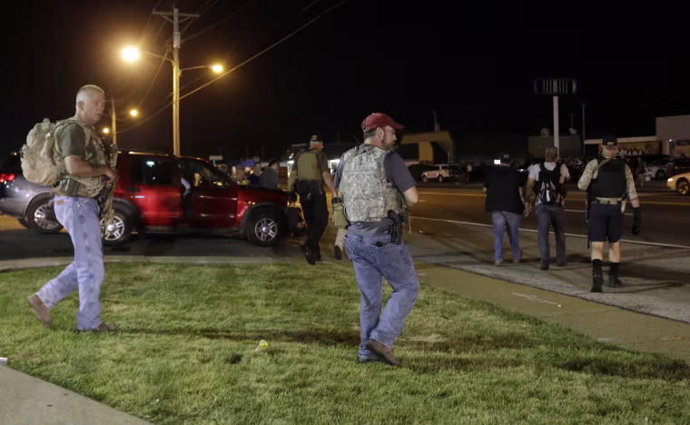 Heavily armed civilians with a group known as the Oath Keepers arrive in Ferguson, Mo., on Aug. 11, 2015.