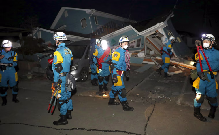 Image: Police officers check collapsed house after an earthquake in Mashiki town, Kumamoto prefecture, southern Japan