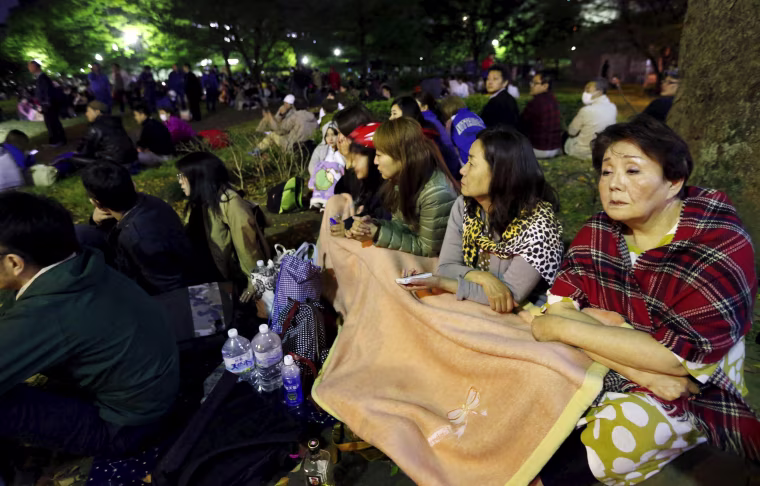 Image: Evacuated residents gather at Shirakawa park after an earthquake in Kumamoto, southern Japan