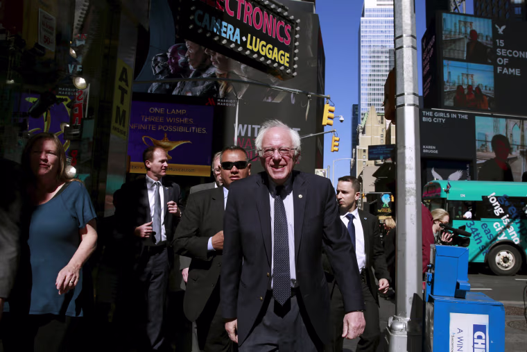Image: Democratic U.S. presidential candidate Bernie Sanders walks around to greet pedestrians in the Times Square neighborhood of the Manhattan borough of New York